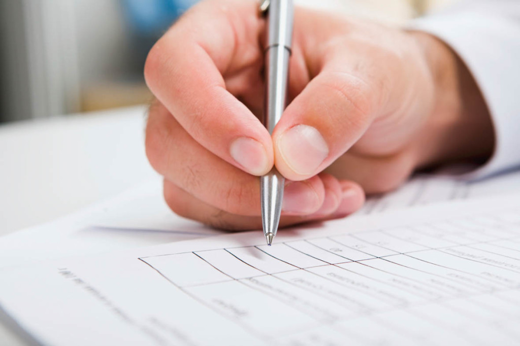 Males hand writing in the document